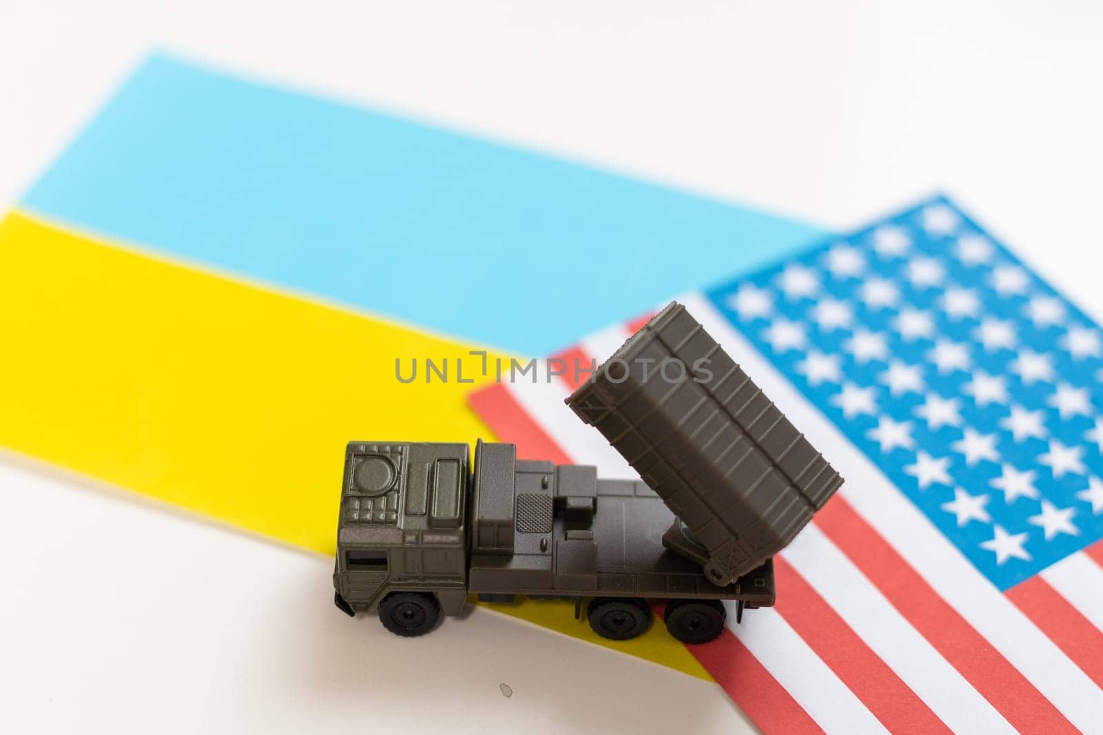 military vehicle and flags of the USA and Ukraine. Defeat of Russia in war in Ukraine concept. High quality photo