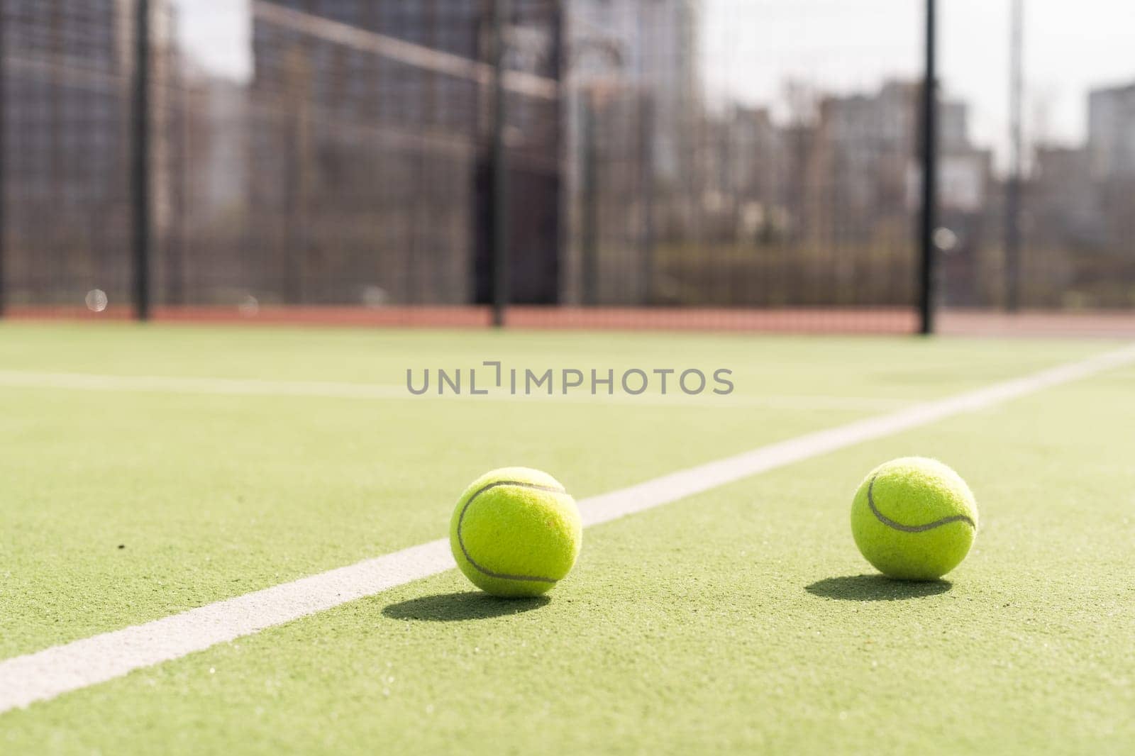 Bright greenish, yellow tennis ball on freshly painted court. High quality photo