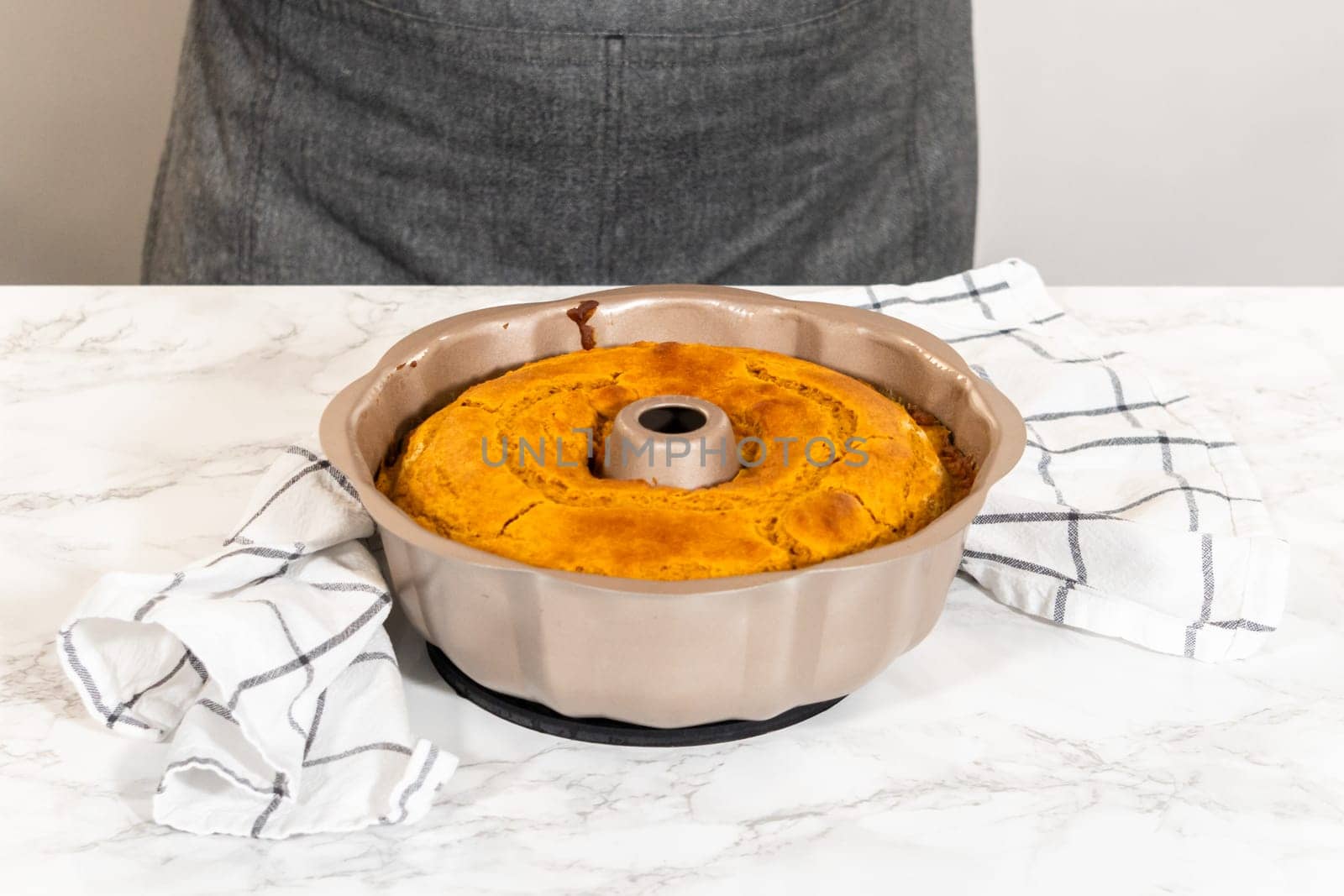 Cooling freshly baked pumpkin bundt cake on the kitchen counter.