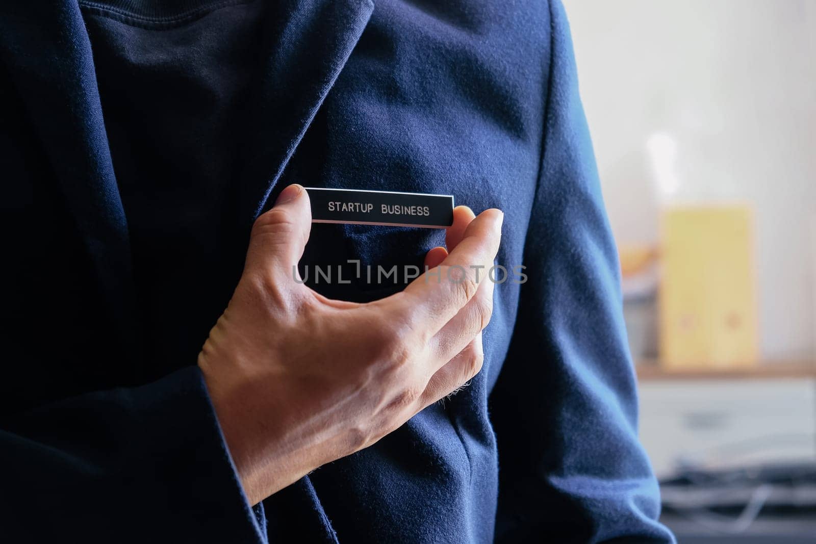 businessman holding a startup business label in his hand, business concept