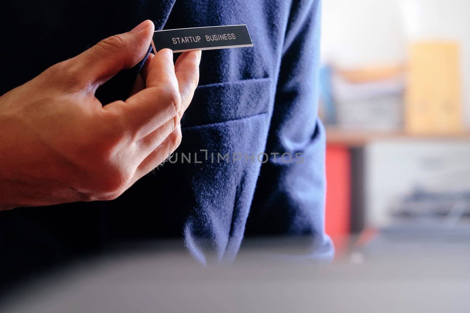 businessman holding a startup business label in his hand, business concept