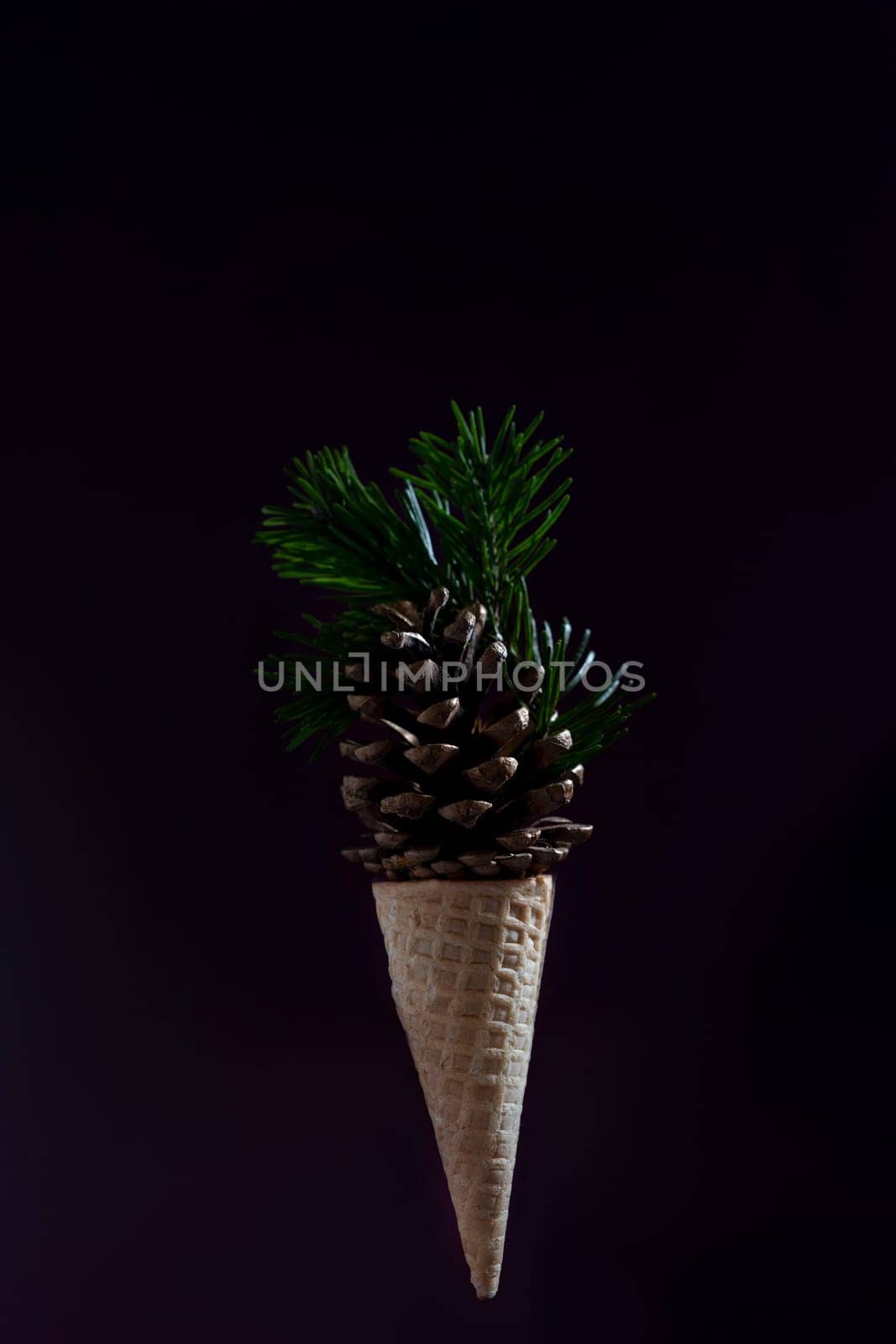 A cone shaped ice cream cone with pine needles on top by Matiunina