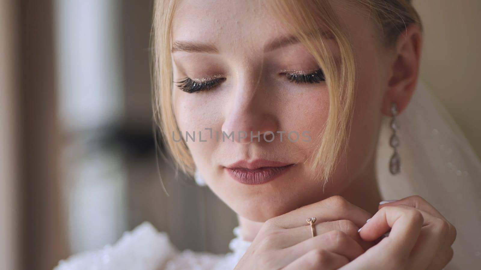 The bride corrects her earring