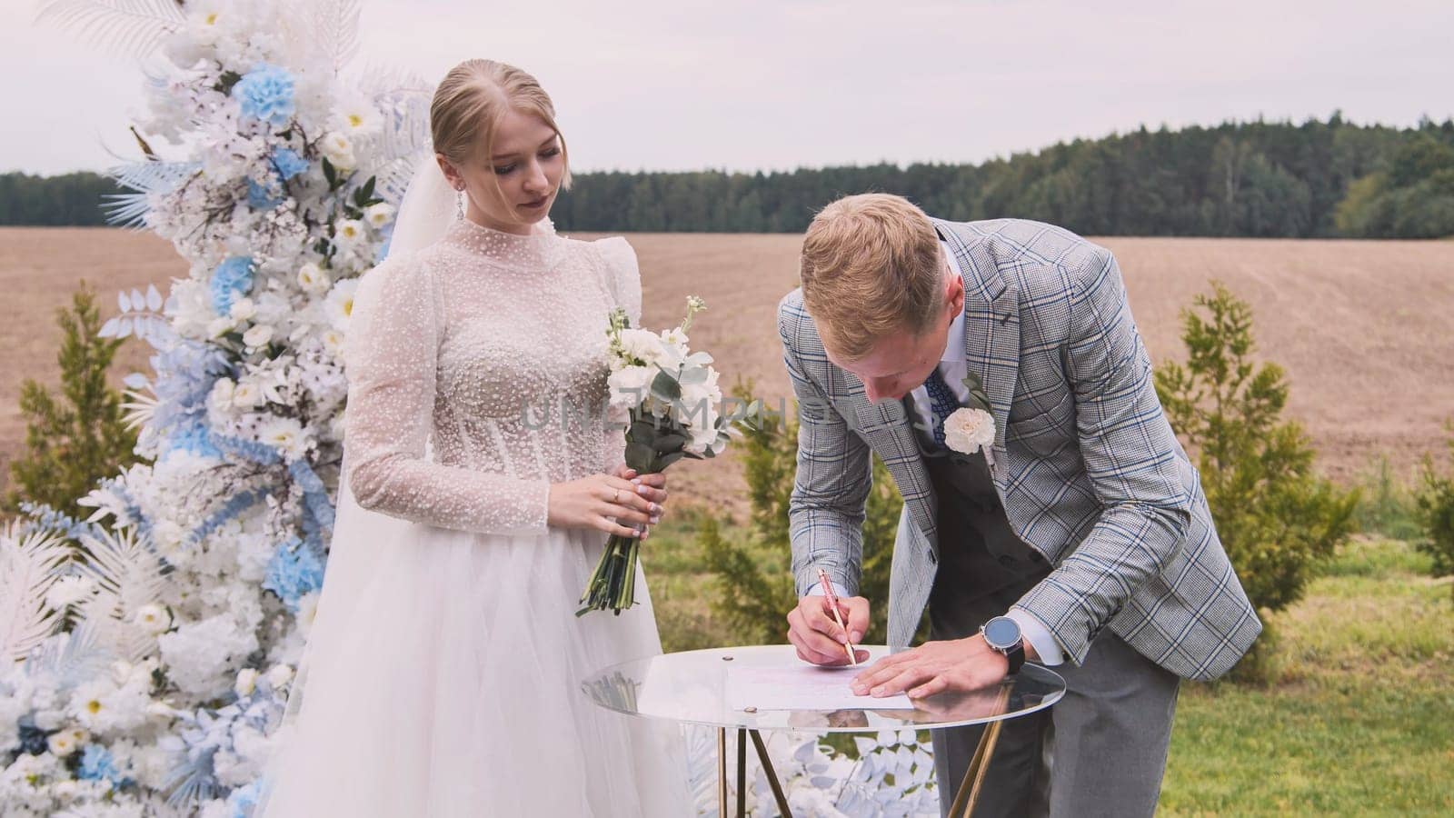 The bride and groom sign the marriage registry on their wedding day.