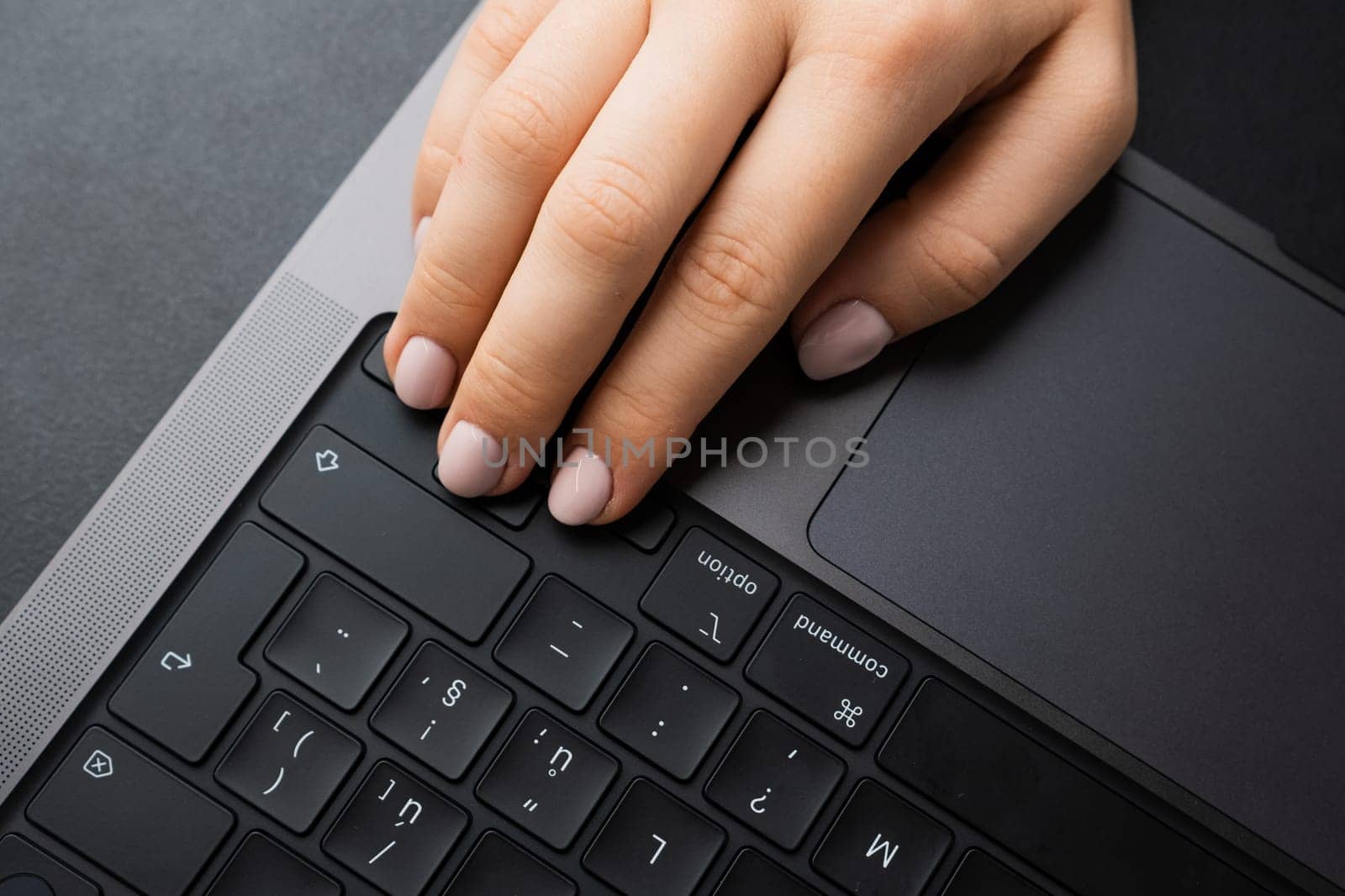 BERLIN, GERMANY - APRIL 14 2024: Female keeps fingers on arrows on keyboard for playing games.