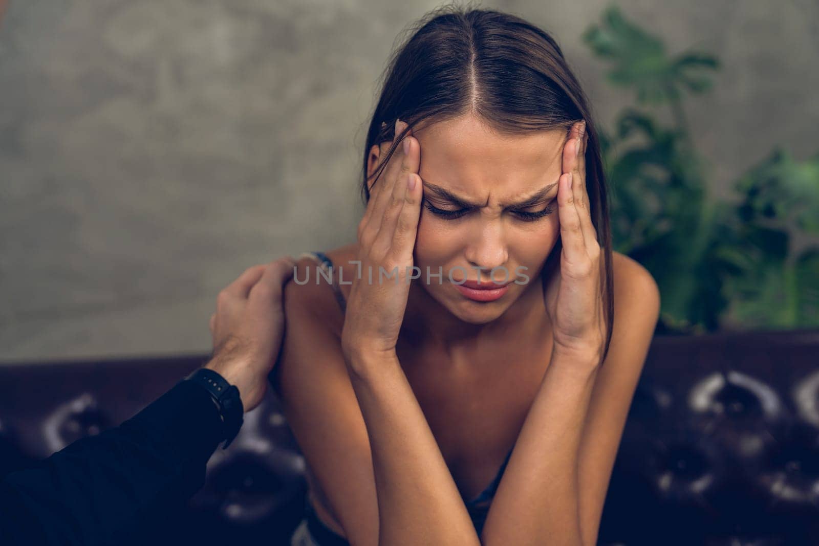 Psychiatrist comforting and supporting stressed and depressed patient with mental illness and depression in office during therapy session. Mental health treatment and medical care concept. Unveiling
