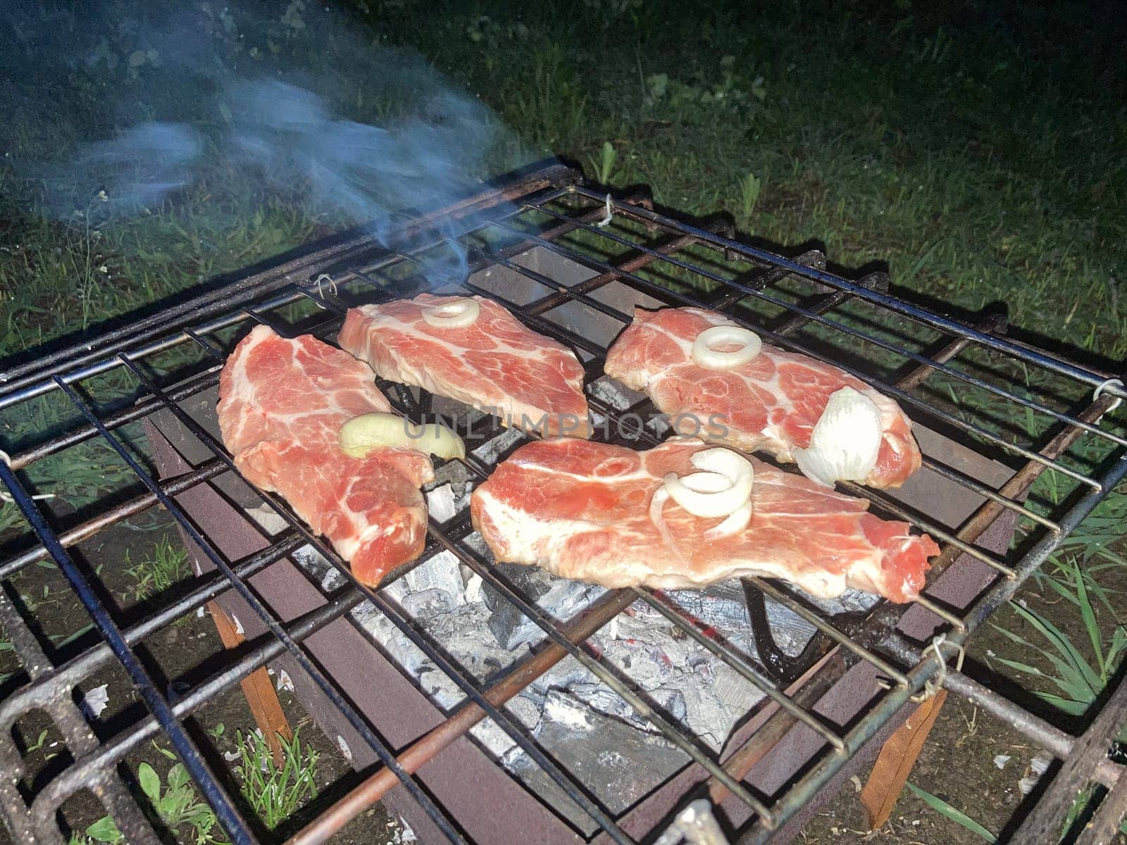 The barbecue grill is lit for the cooking outdoors