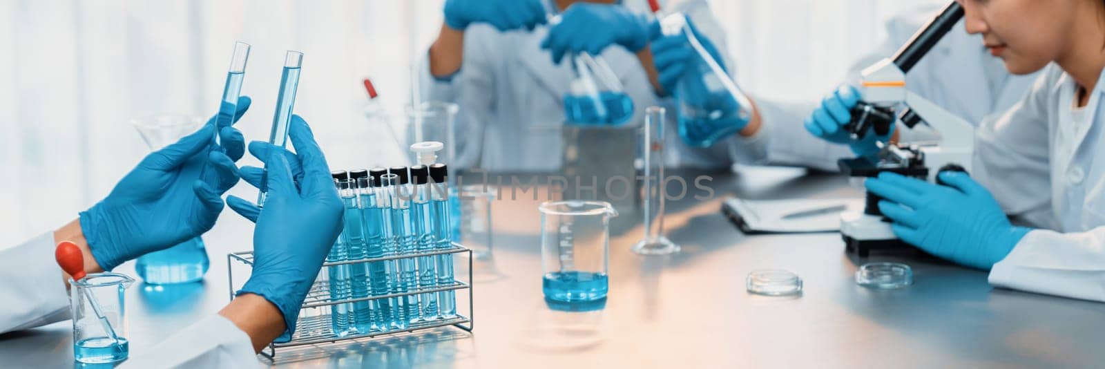 Group of dedicated scientist conduct chemical experiments and research in medical lab as groundbreaking developing for vaccine drug or antibiotic. Pharmaceutical and biochemistry laboratory. Neoteric