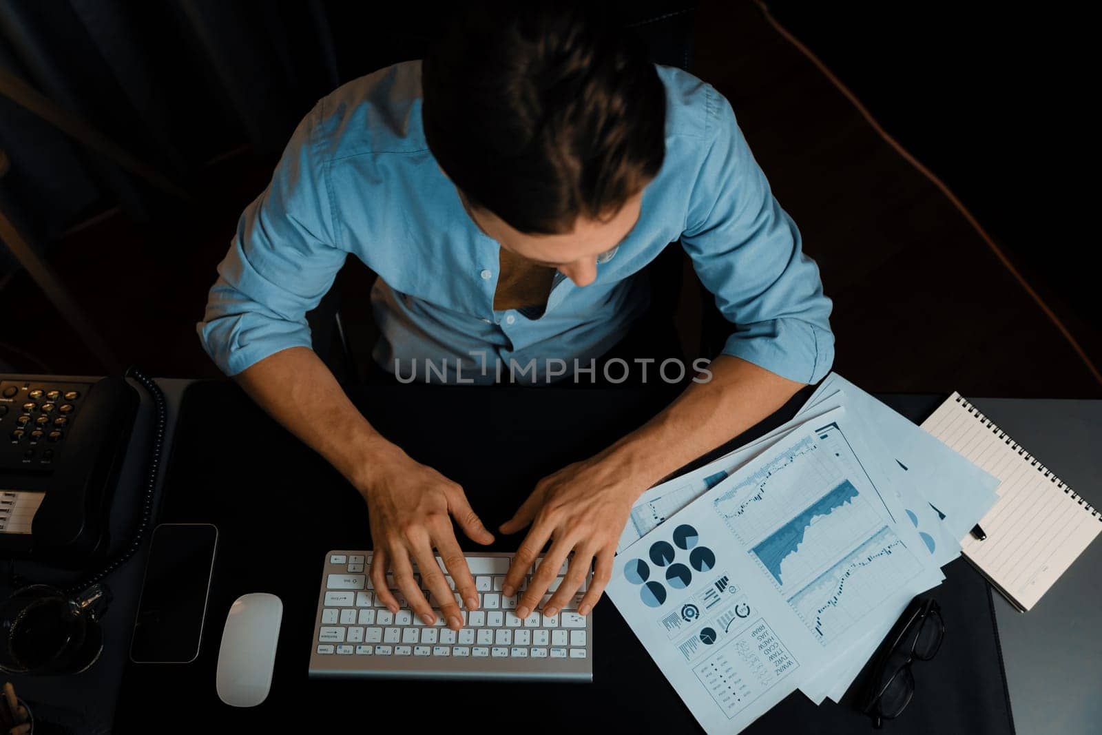 Top view smart businessman analyzing business paragraph dynamic database marketing analysis plan surrounded paper sheet, pc monitor report to compare with document data at home office. Pecuniary.