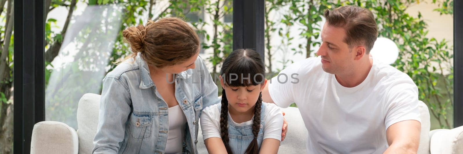 Parents comforting their daughter with loving hug, helping her feel secure and protected from fear, rest her head on shoulder. Happy family love and child care support concept. Panorama Synchronos