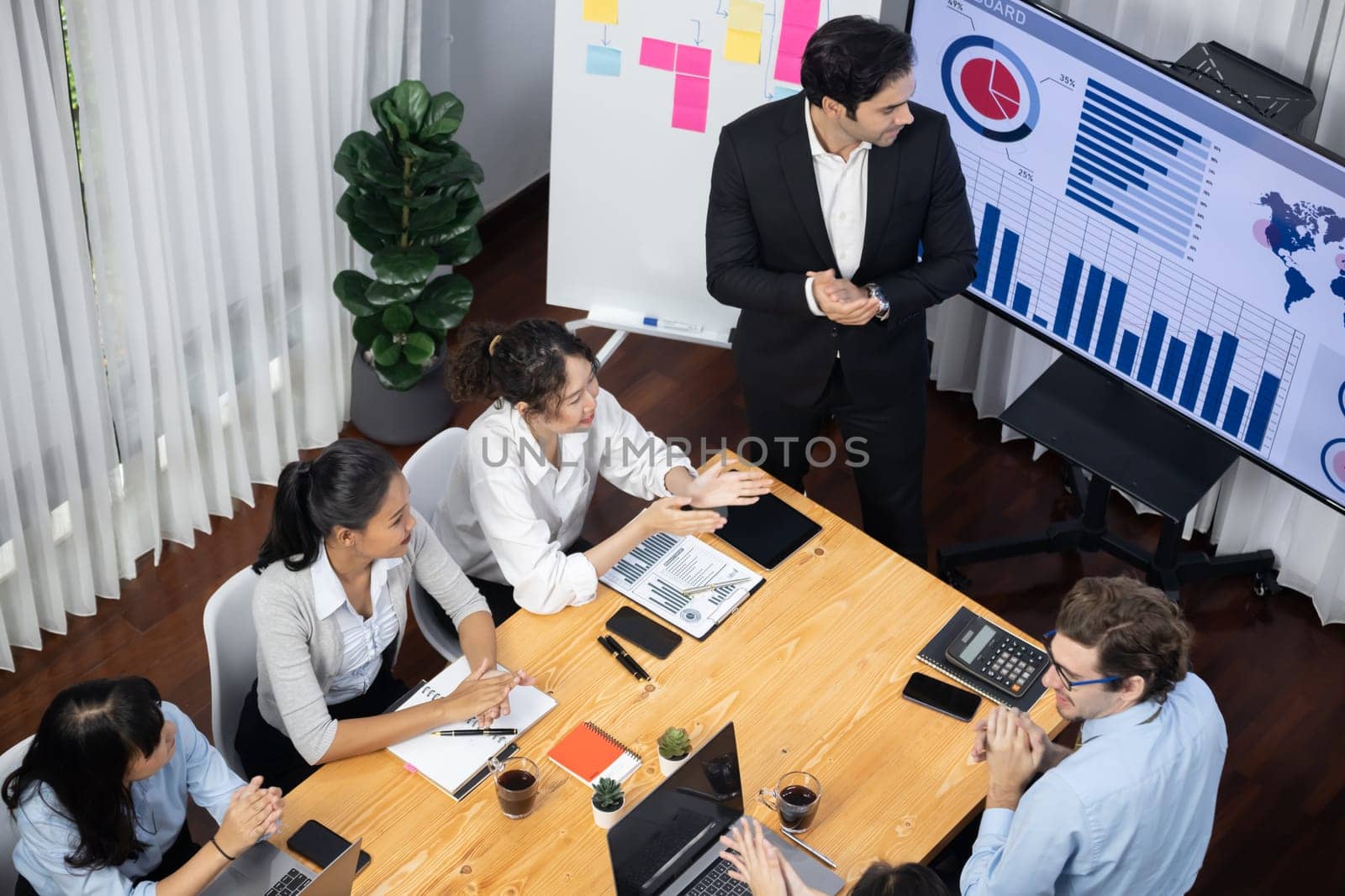 Wide top view diverse analyst team analyzing financial data. Meticulous by biancoblue