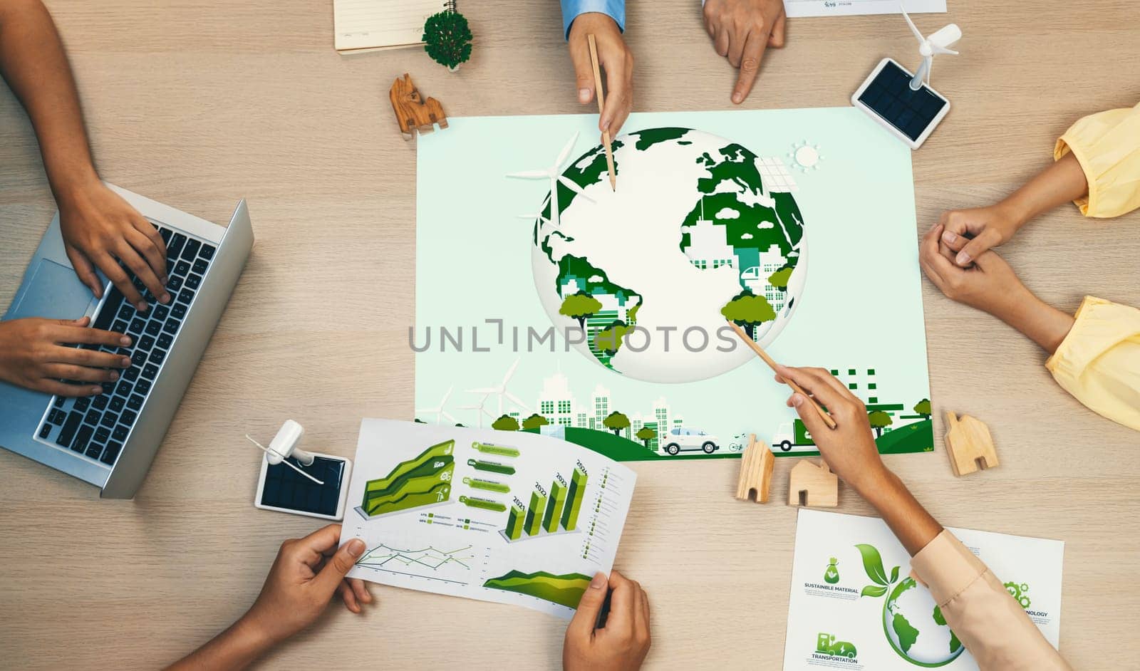 Green city illustration placed on green business meeting table. Delineation. by biancoblue