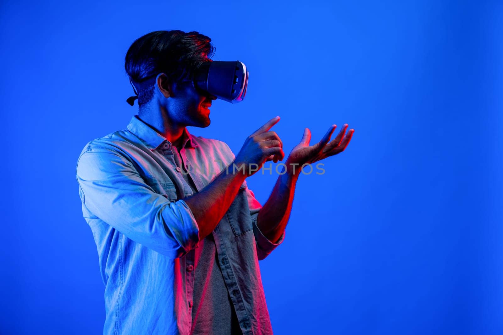 Caucasian man with VR glasses while holding hologram display in VR. Deviation. by biancoblue