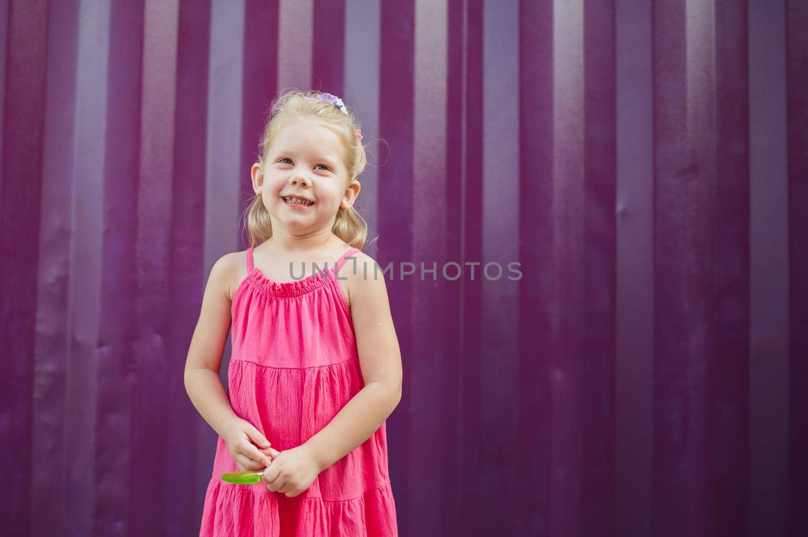 Child girl with hearing aids and cochlear implants having fun outdoor speak and playing. Copy space and empty place for advertising.