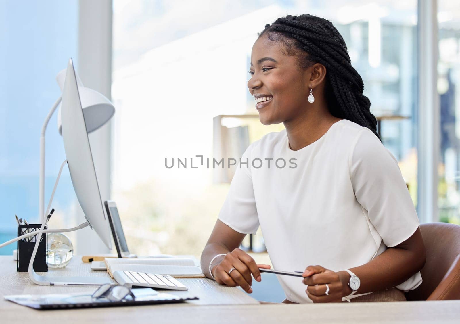 African woman, office and computer for working, research and online report for web article. Reporter, technology and smile for startup, news agency or creative writing for New York affirmative action.