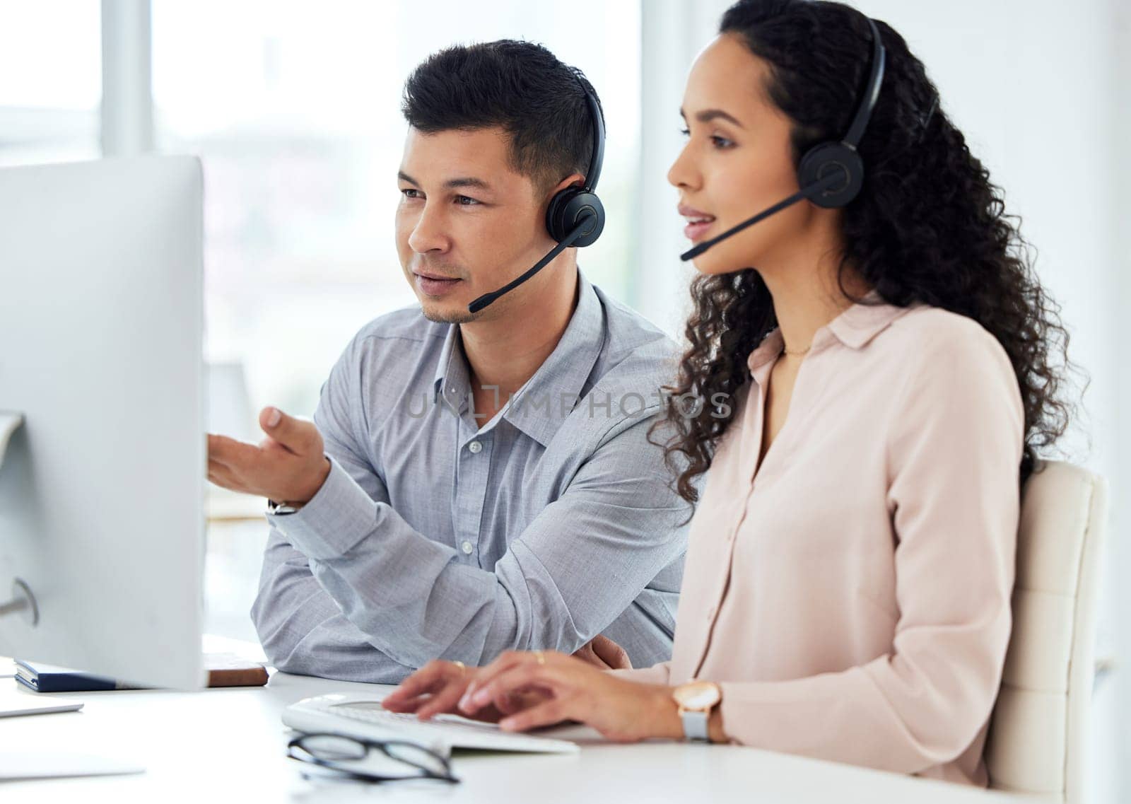Call centre, man and woman with manager, typing and computer for website and market research online. Tech support, help and customer service with headset or headphones, training and communication.