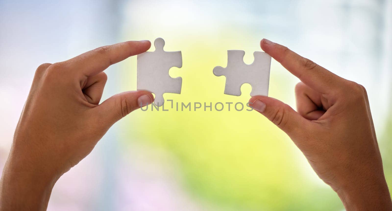 Hands, puzzle and office for business solution with connection, synergy or integration at company. Person, toys and creativity for problem solving, strategy or link with ideas for vision in workplace.