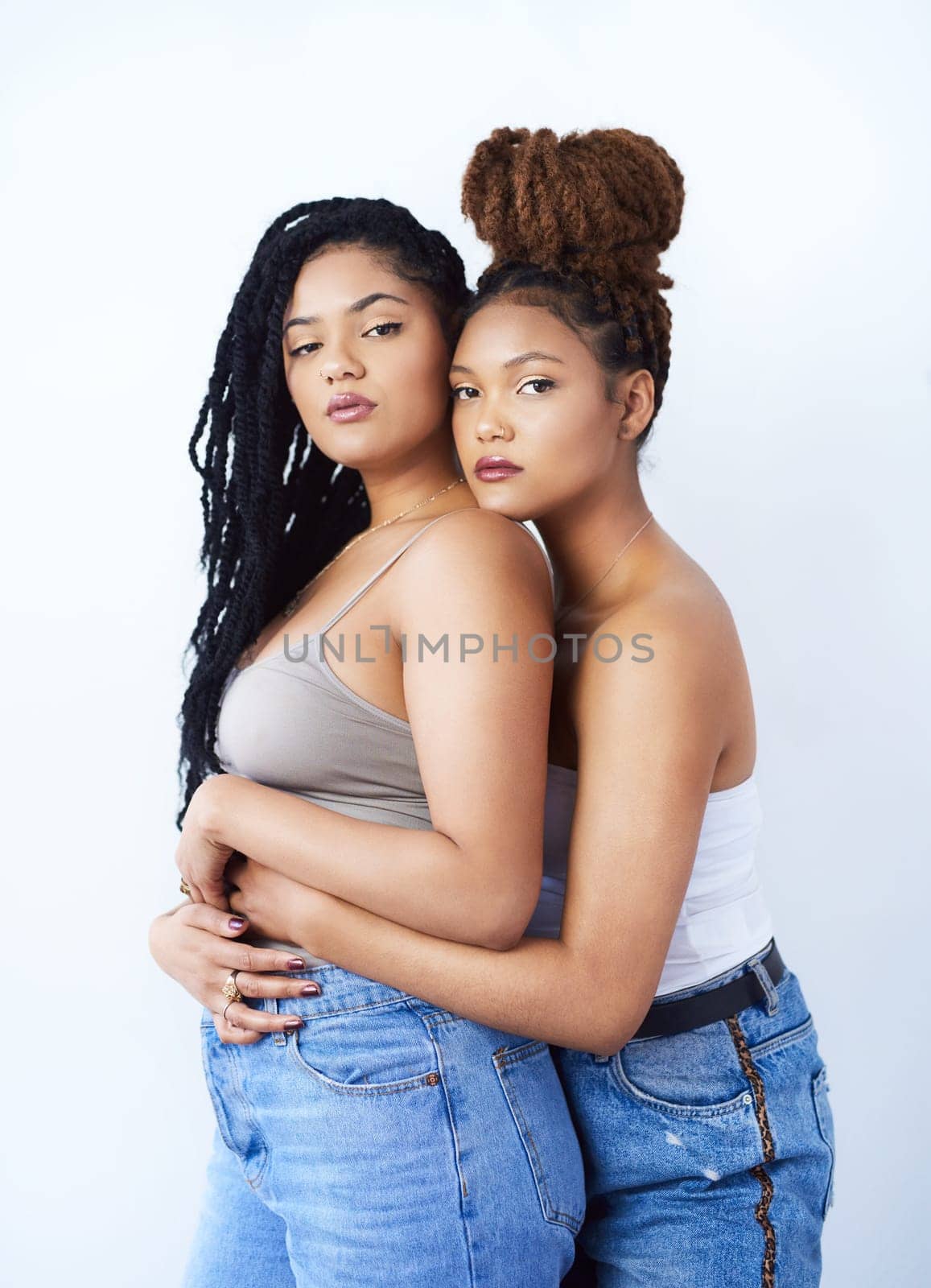 Studio, portrait and lgbtq with women in fashion for solidarity, support and gay pride on white background. Serious, lesbian and couple with embrace in love for care, style and confidence together.