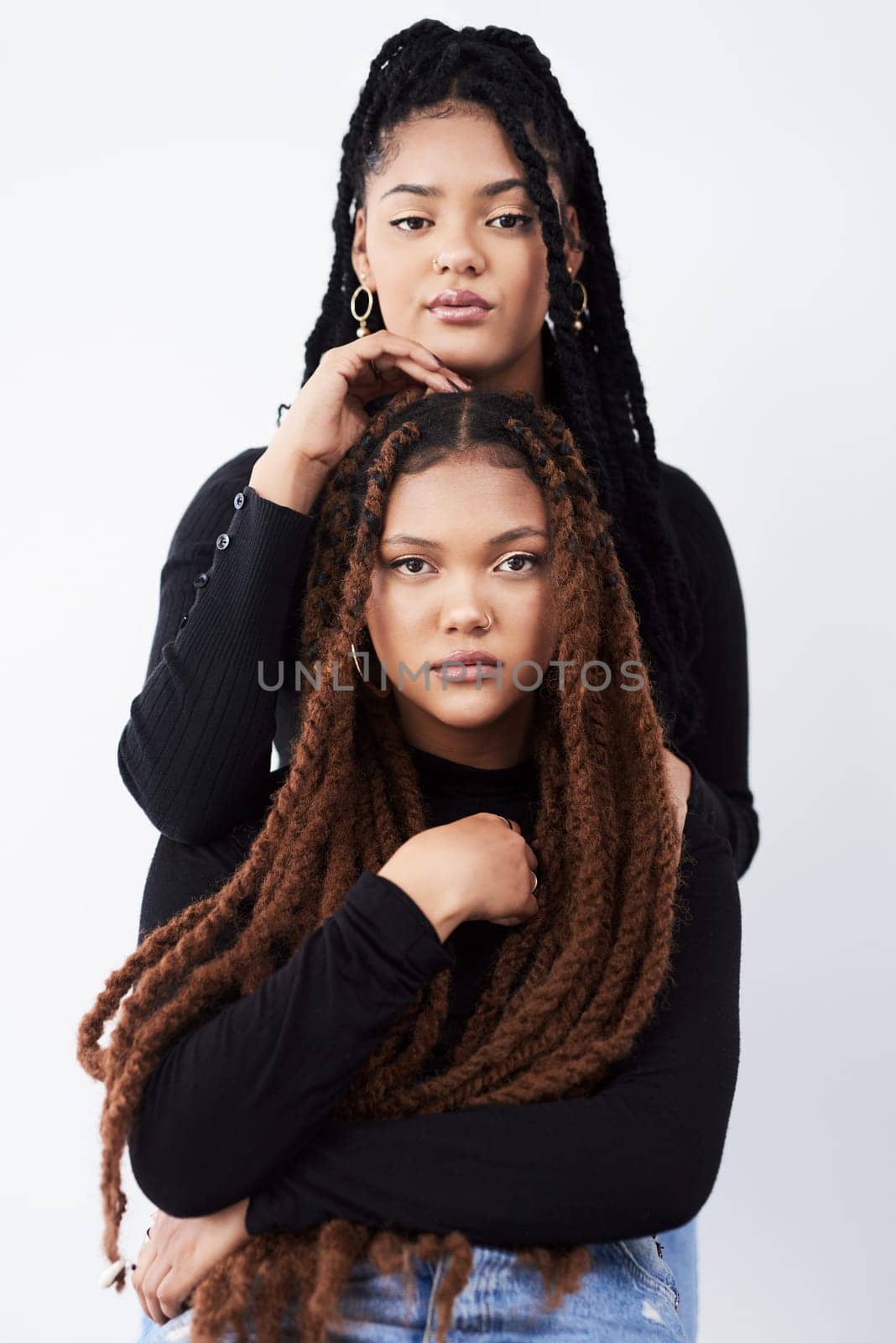 Lesbian couple, portrait and fashion in studio with pride for style inspiration, jeans and together. Serious, lgbt and black people for support with women, relationship and dreadlocks with clothes by YuriArcurs