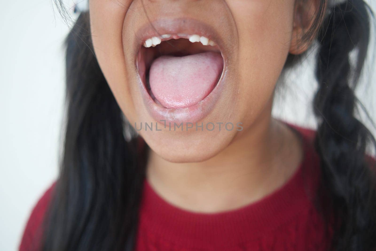 close up of child screaming at home by towfiq007