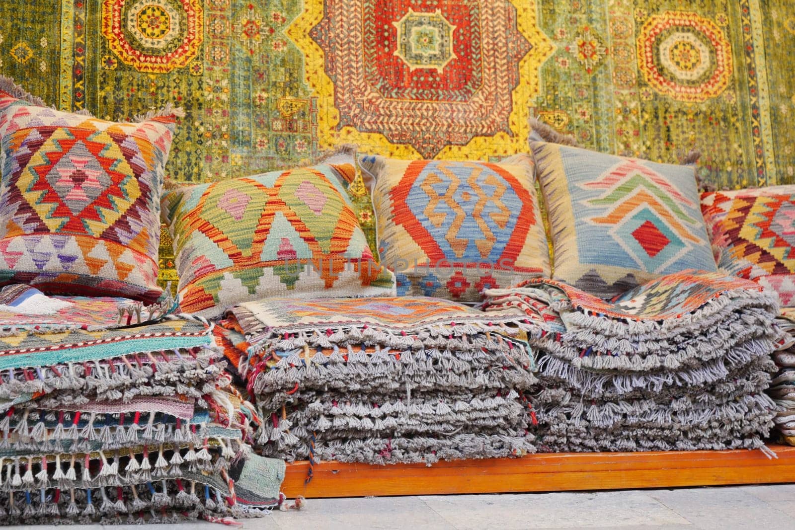 Colourful cushions and carpet on display for sale in a traditional Turkish Bazaar. by towfiq007