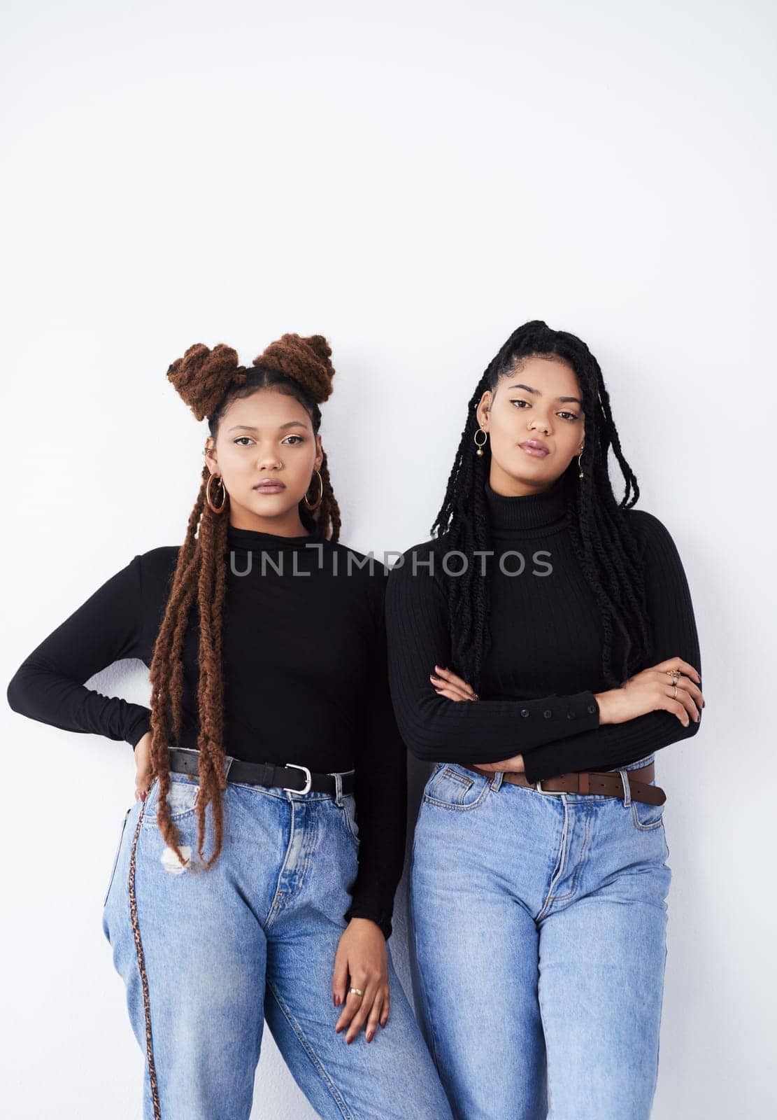 Sisters, portrait and fashion in studio, confident and style bonding on white background. Women, friends and care for relationship on backdrop, casual outfit and matching trend for gen z or support.