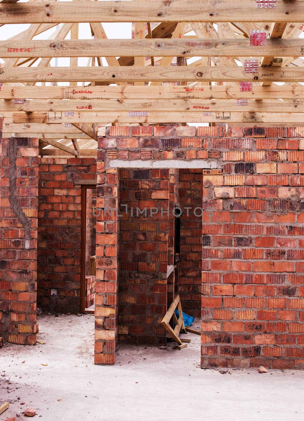 Property, brick wall and new real estate project for construction, development and dream home frame. House, building and architecture with structure, worksite and suburban improvement and design by YuriArcurs
