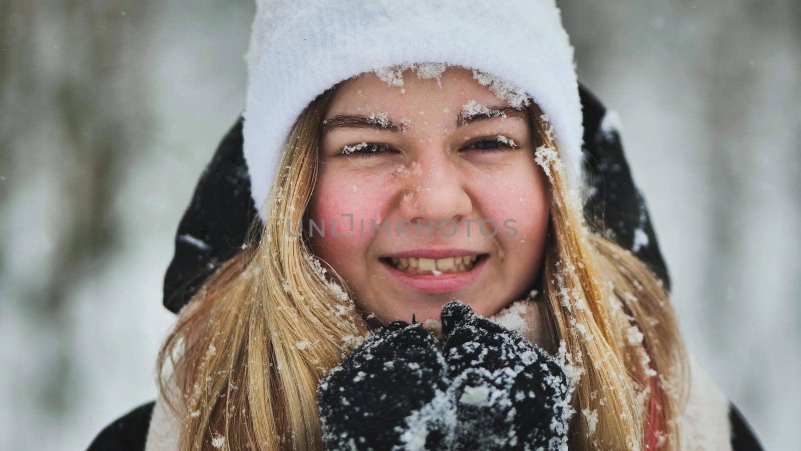 A young girl freezes in the woods in winter. by DovidPro