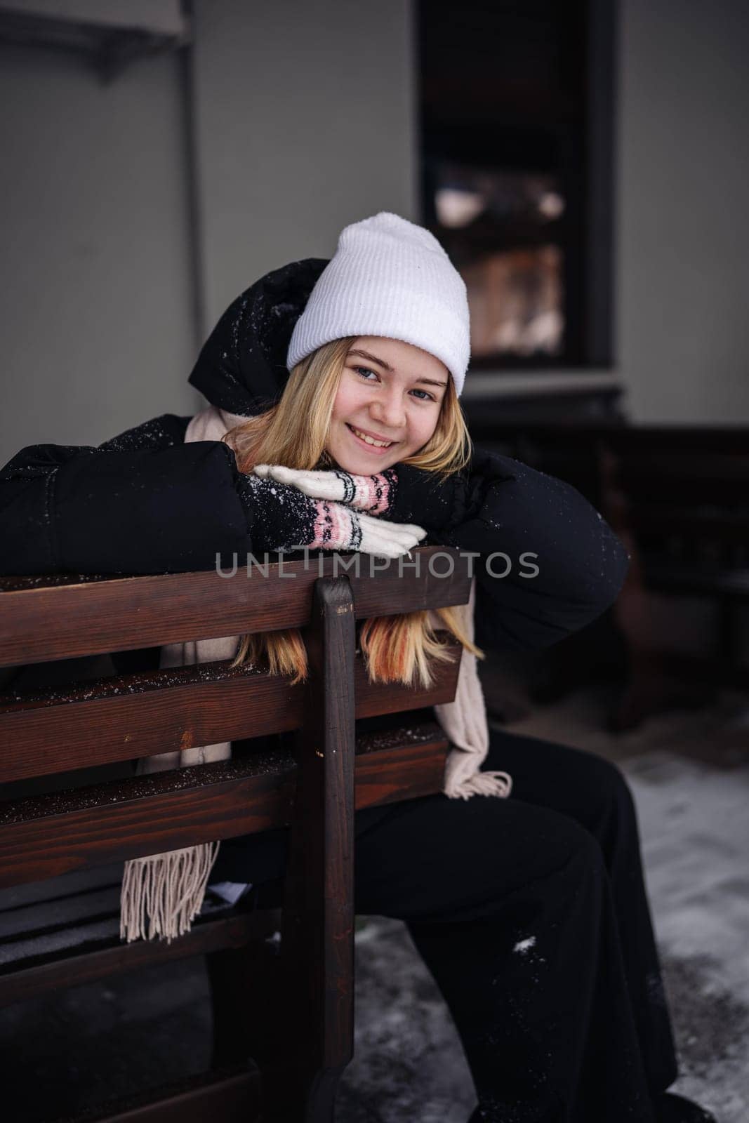 Portrait of a teenage girl outside a cafe in winter. by DovidPro