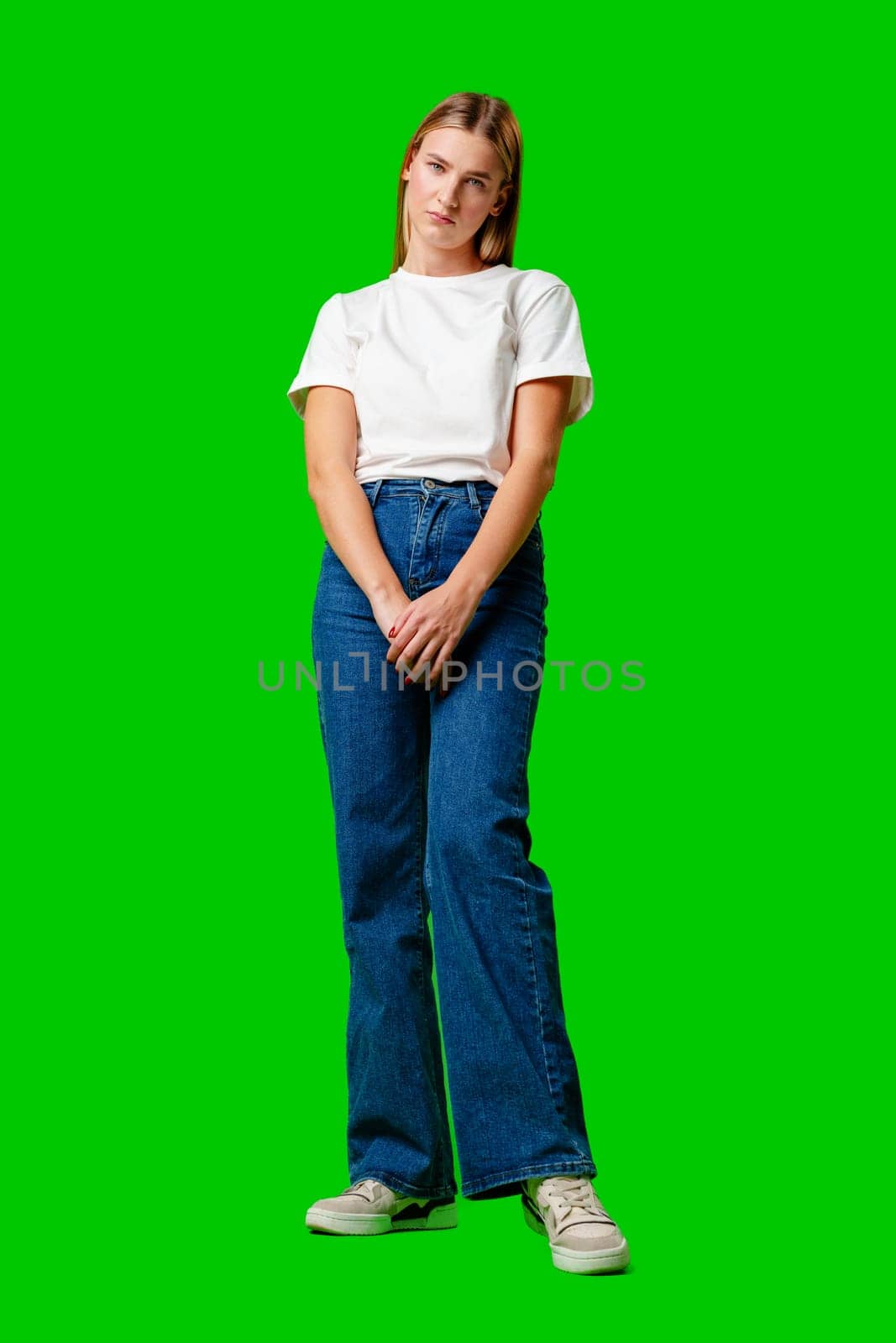 Young Woman With Pursed Lips Expressing Skepticism Against Green Screen Background in studio