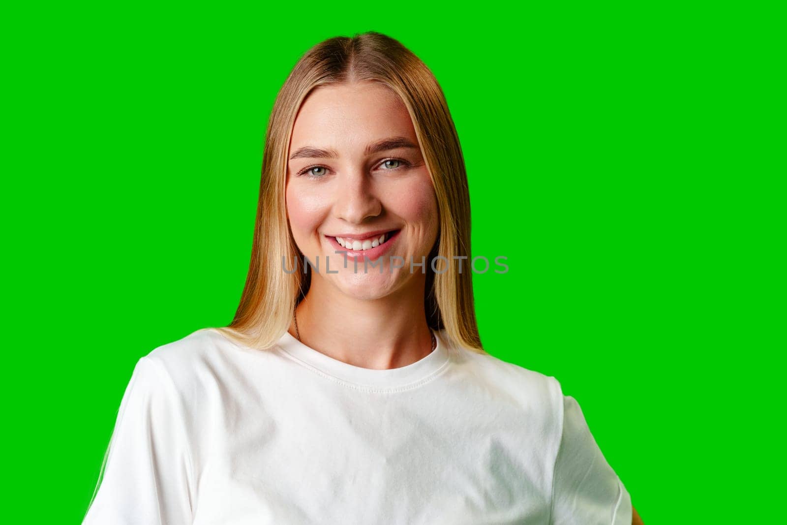 Young Woman in White Shirt Posing for Picture against green background by Fabrikasimf
