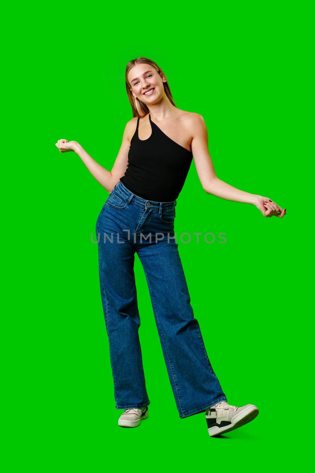 Young Woman Poses for Picture against green background. by Fabrikasimf