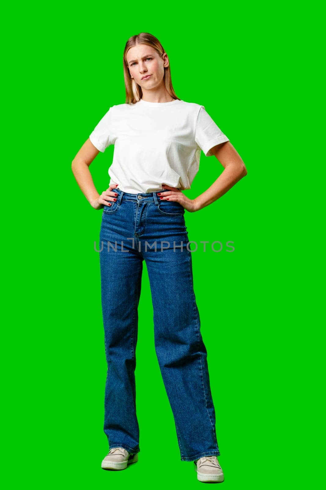 Young Woman With Pursed Lips Expressing Skepticism Against Green Screen Background by Fabrikasimf