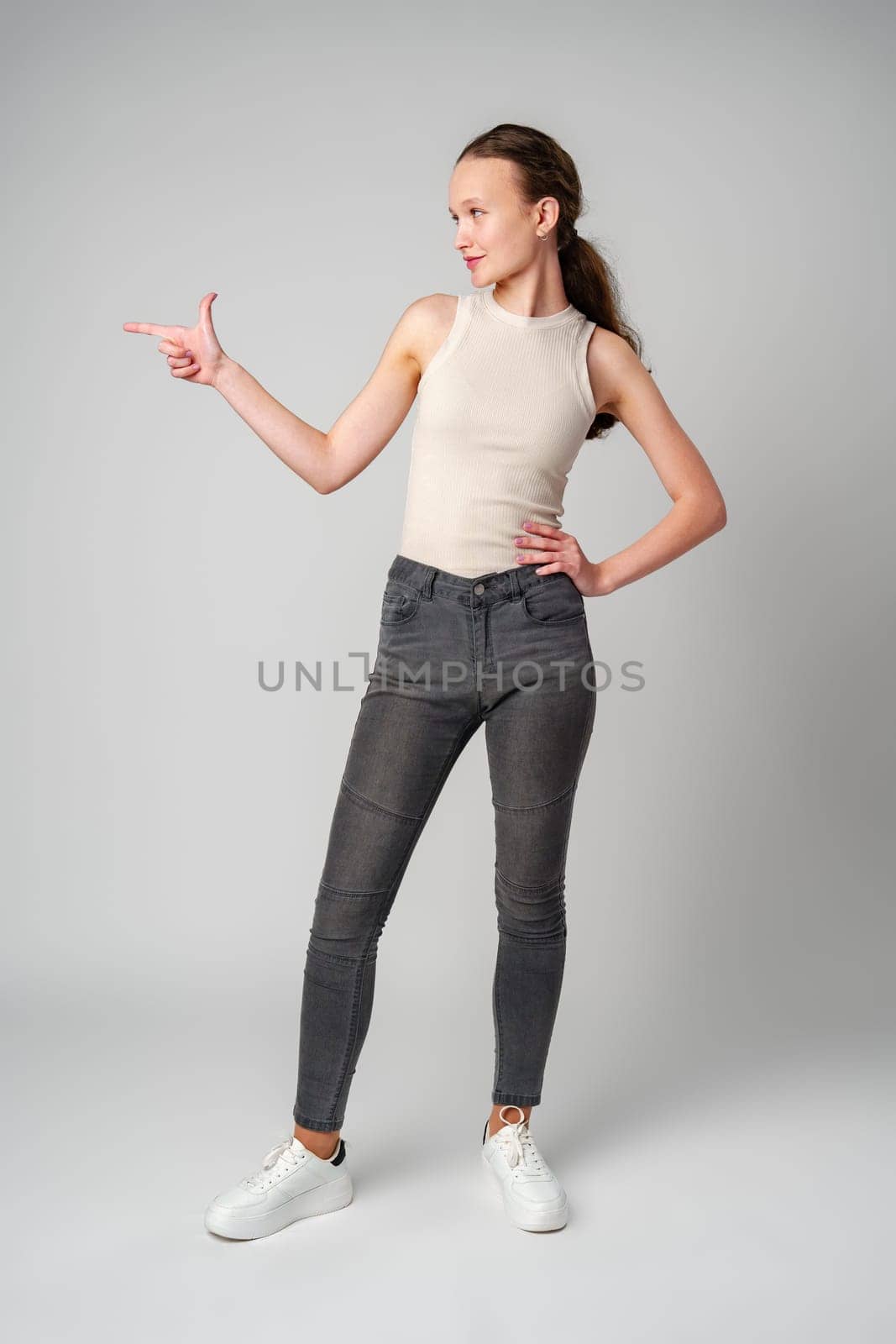 Woman in White Top Pointing at Something in studio