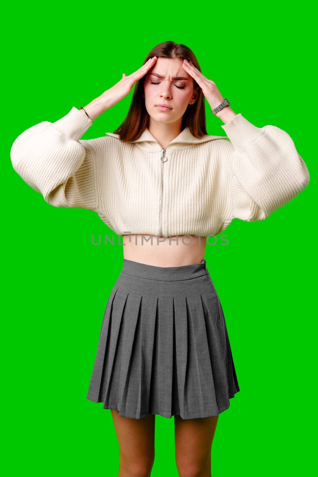 A woman wearing a skirt is shown holding her hands to her head in a gesture of distress or frustration. She appears to be deep in thought or experiencing a moment of intense emotion.