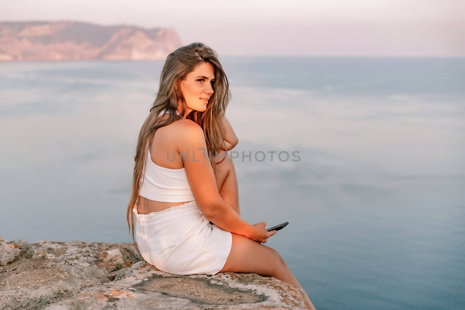 Portrait of a happy woman with long hair against the sea.