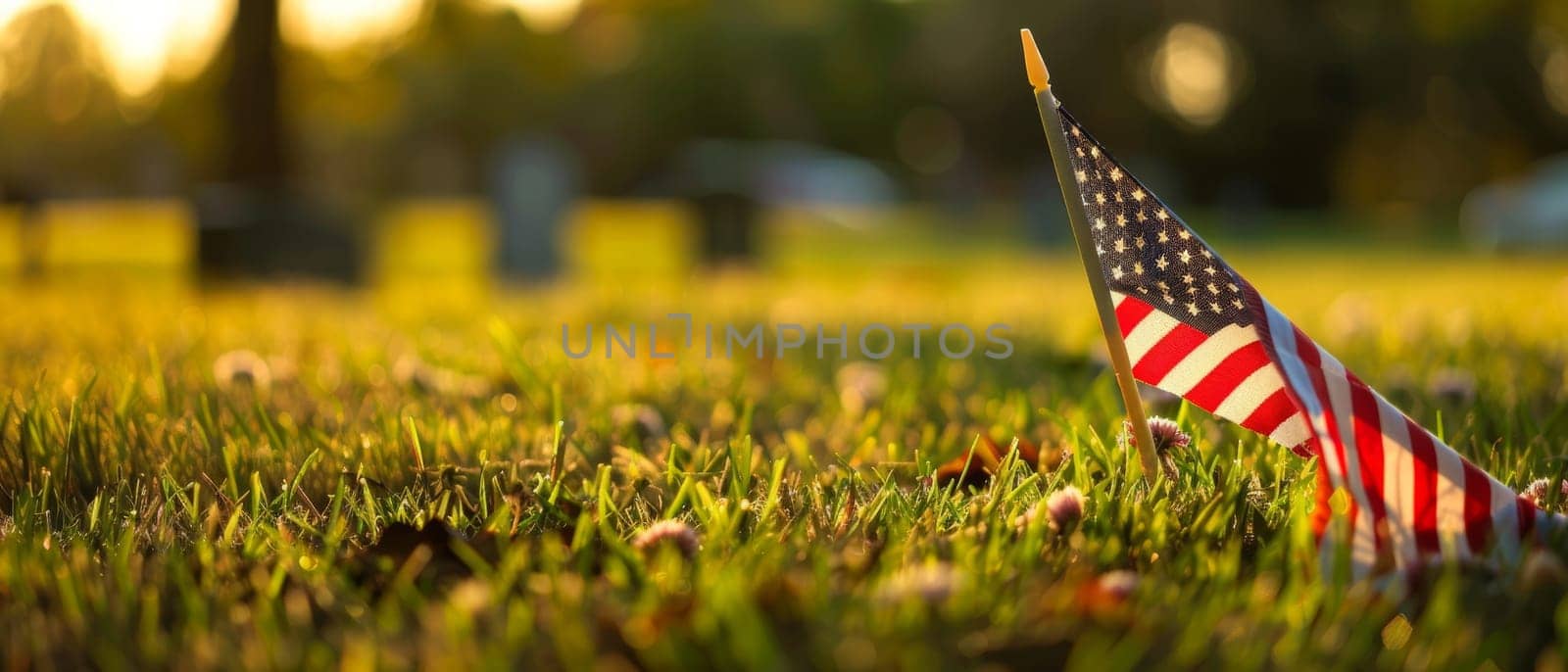 The American flag takes a poignant stand in the soft light of dusk at a memorial park, symbolizing reflection and pride. by sfinks