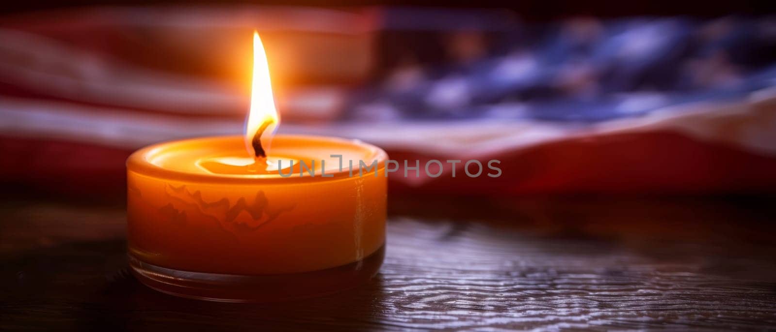 An ornate, flag-patterned candle burns brightly, its flickering flame a symbol of the enduring spirit and sacrifice of those honored on Memorial Day. by sfinks