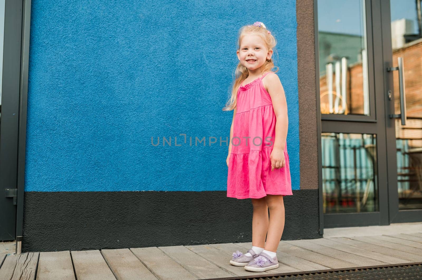 Child girl with hearing aids and cochlear implants having fun outdoor speak and playing. Copy space and empty place for advertising.
