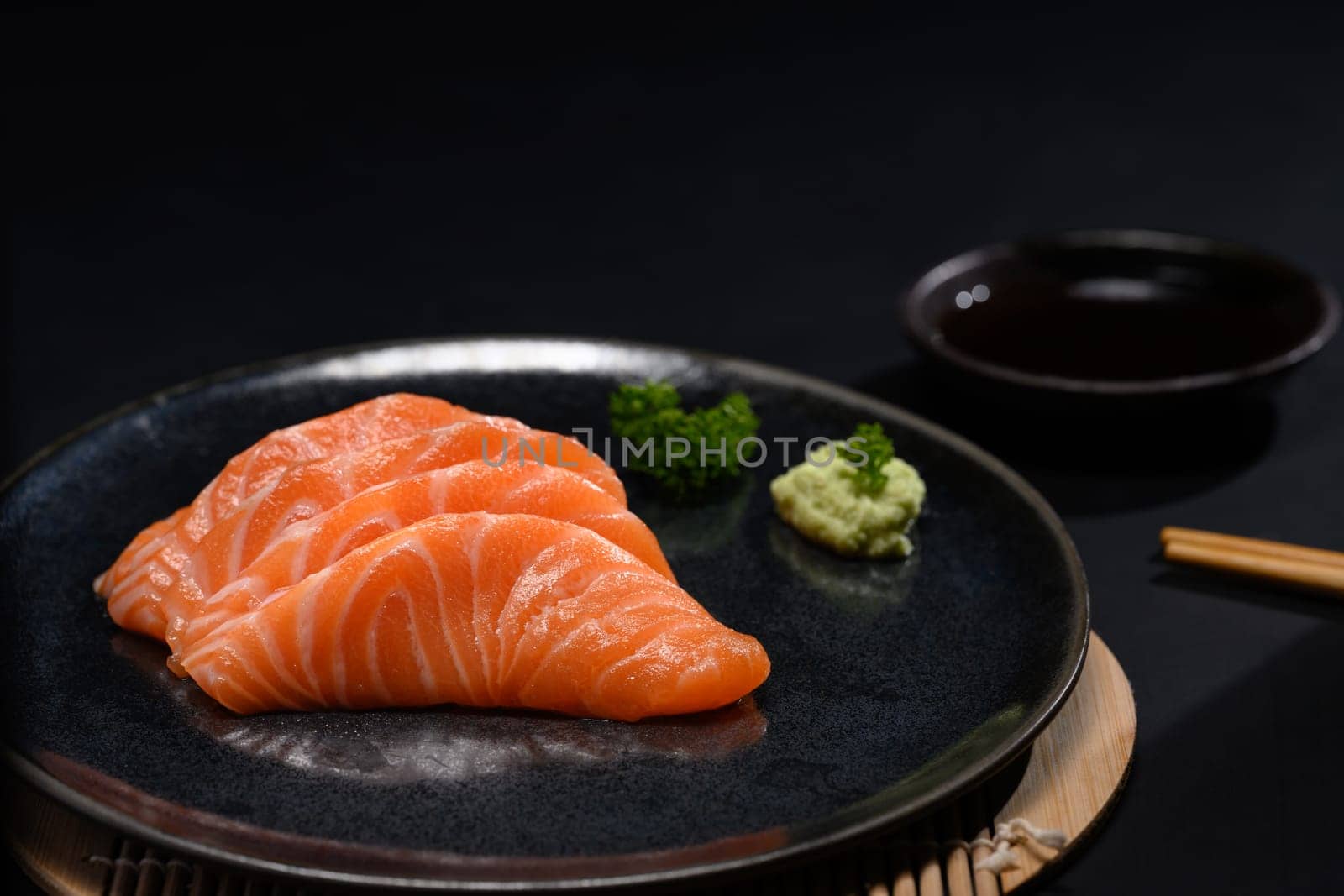 Sliced raw fatty salmon or salmon sashimi serve on with wasabi. Japanese food style concept.