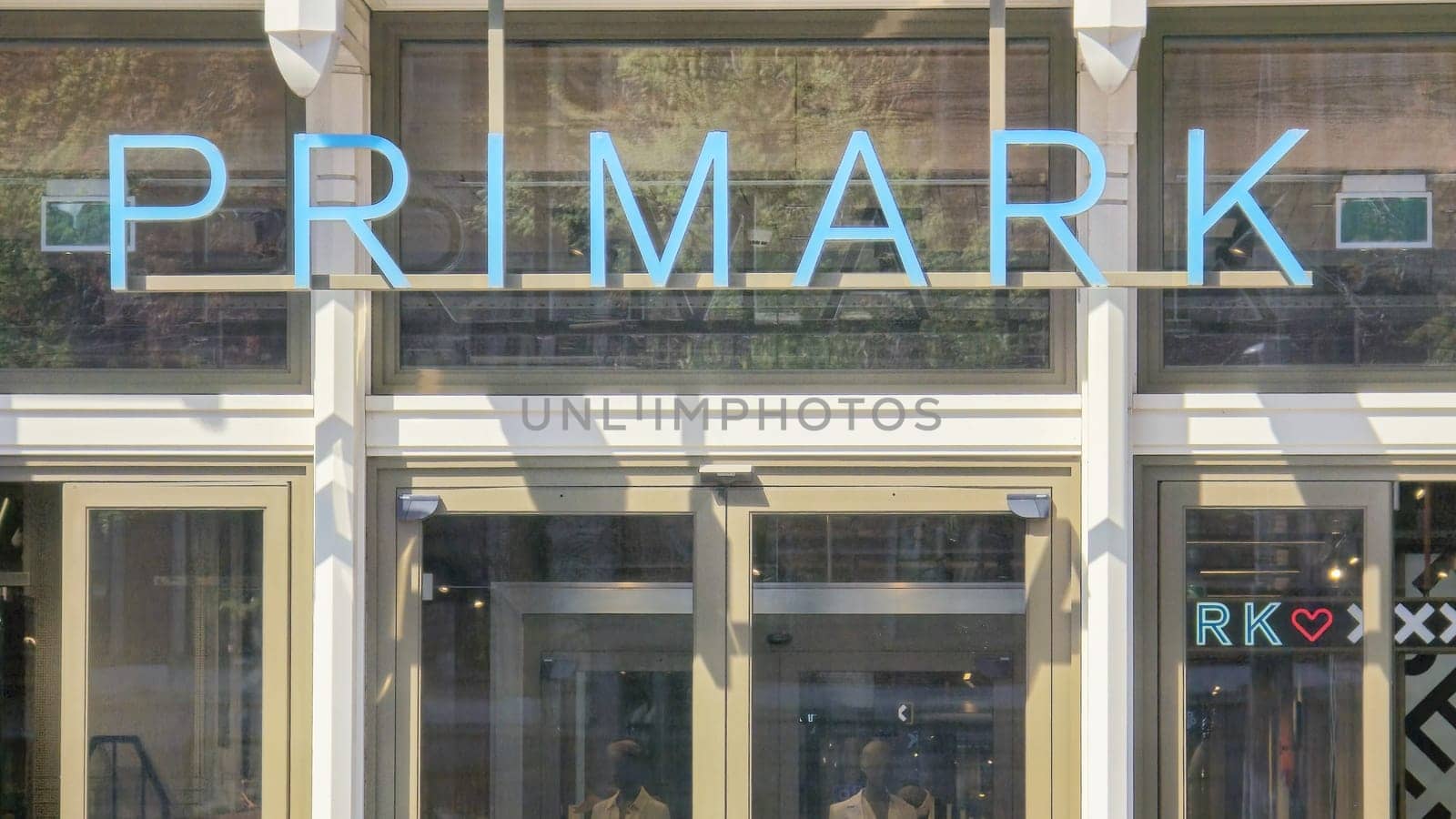 A majestic building adorned with a vibrant sign that reads Primark, inviting fashion-forward individuals to explore trendy clothing options by fokkebok