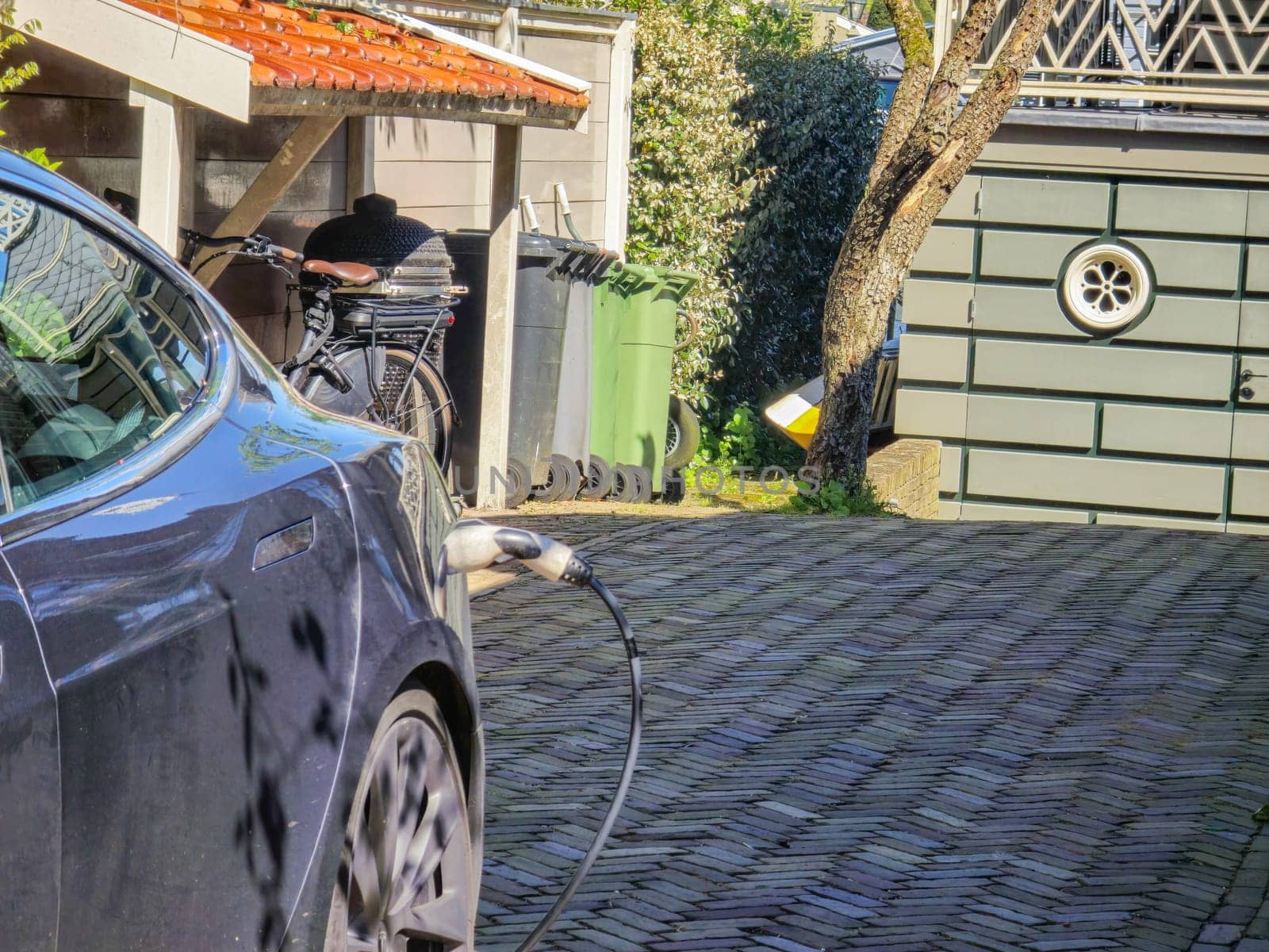 EV charging station for electric car in concept of green energy and eco power by fokkebok