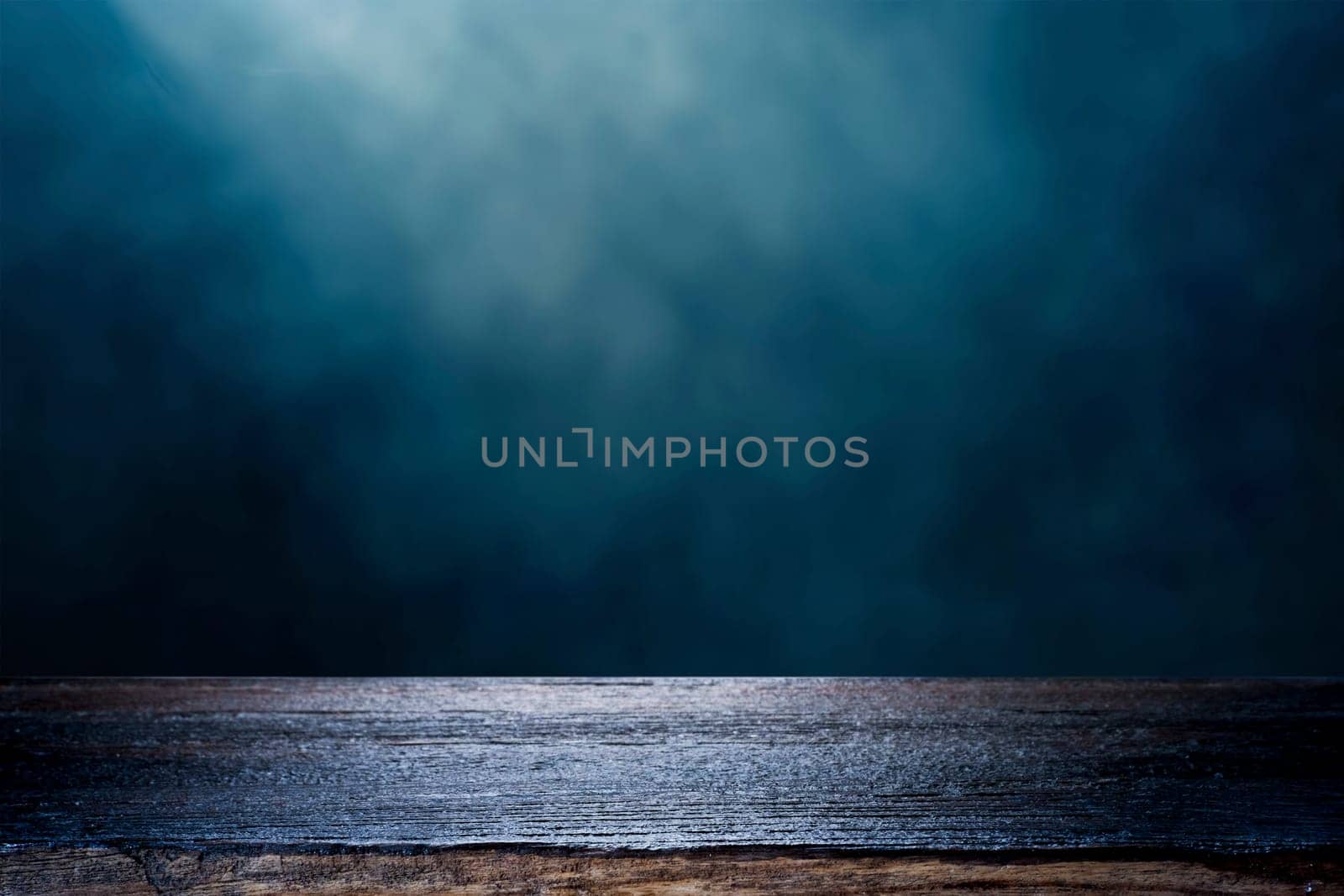 Rustic Wooden Table Surface with Misty Dark Blue Background. by ijeab