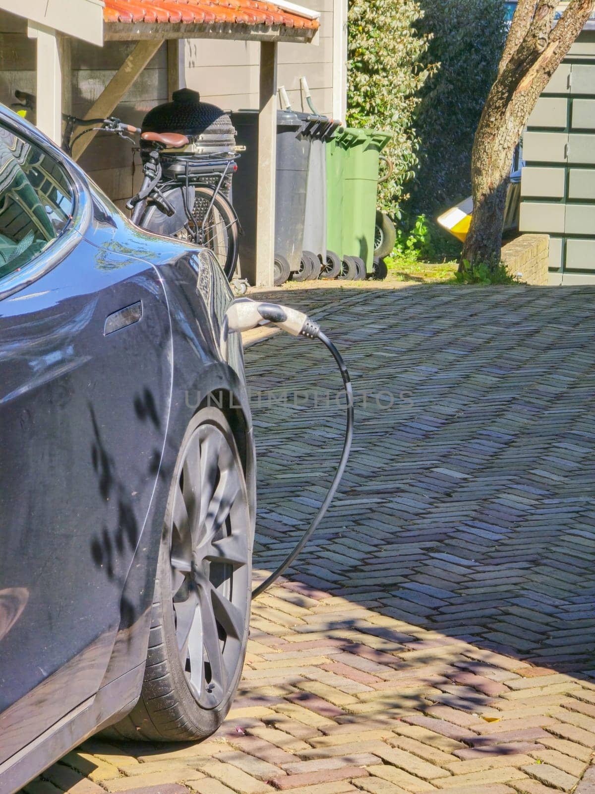 EV charging station for electric car in concept of green energy and eco power by fokkebok