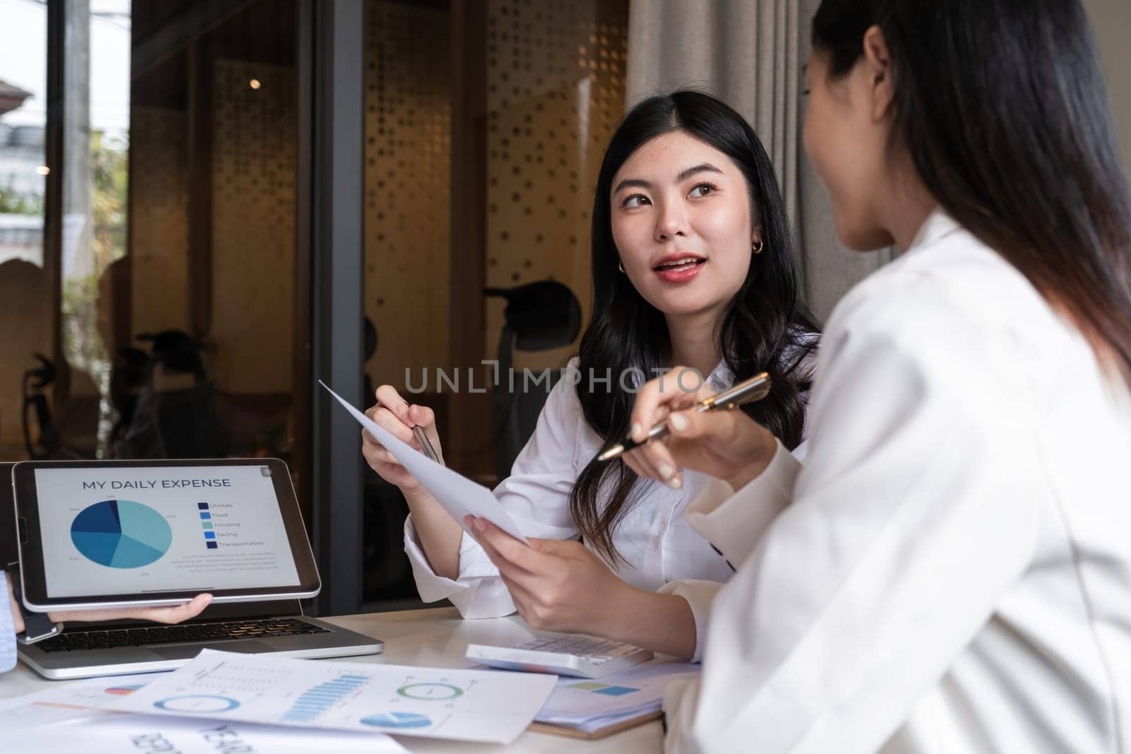 A team of business people brainstorm together about a work plan. Business management and discussing ways to work together in the meeting room.