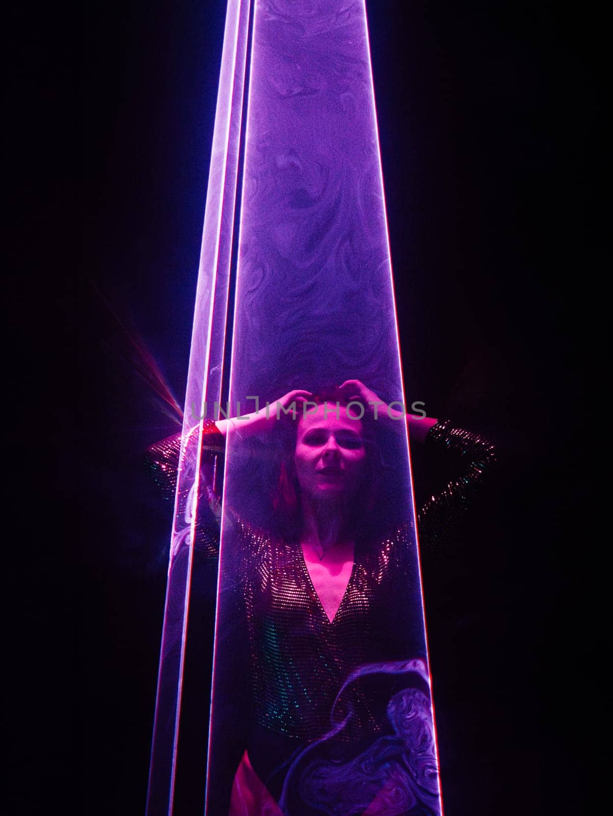 Beautiful woman under violet illumination, laser light, neon party night club. Performance, projection mapping. Interactive exposition installation. by kristina_kokhanova
