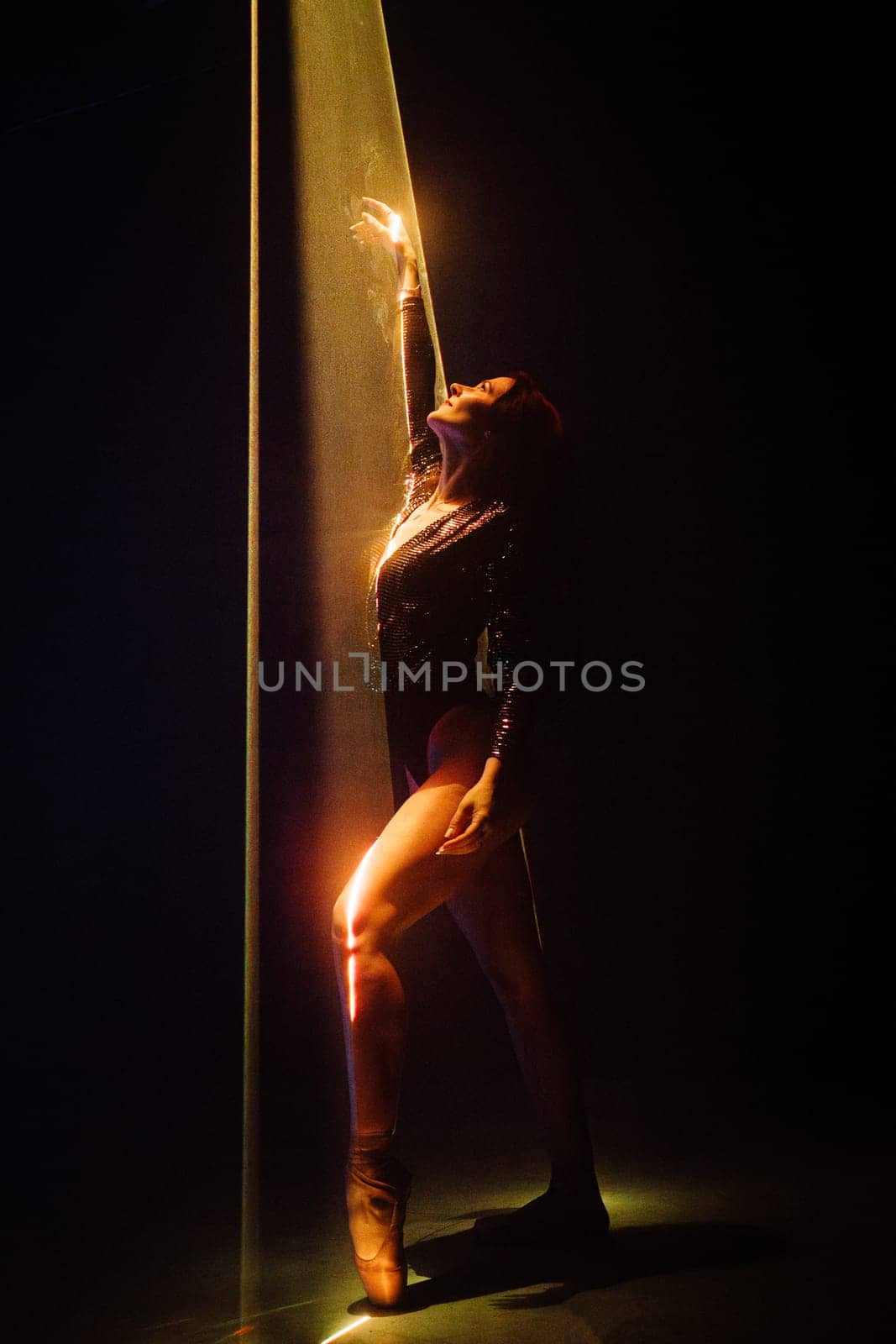 Beautiful ballerina woman dancing under colorful illumination, laser light, neon party night club. Performance, projection mapping. Interactive exposition installation. by kristina_kokhanova