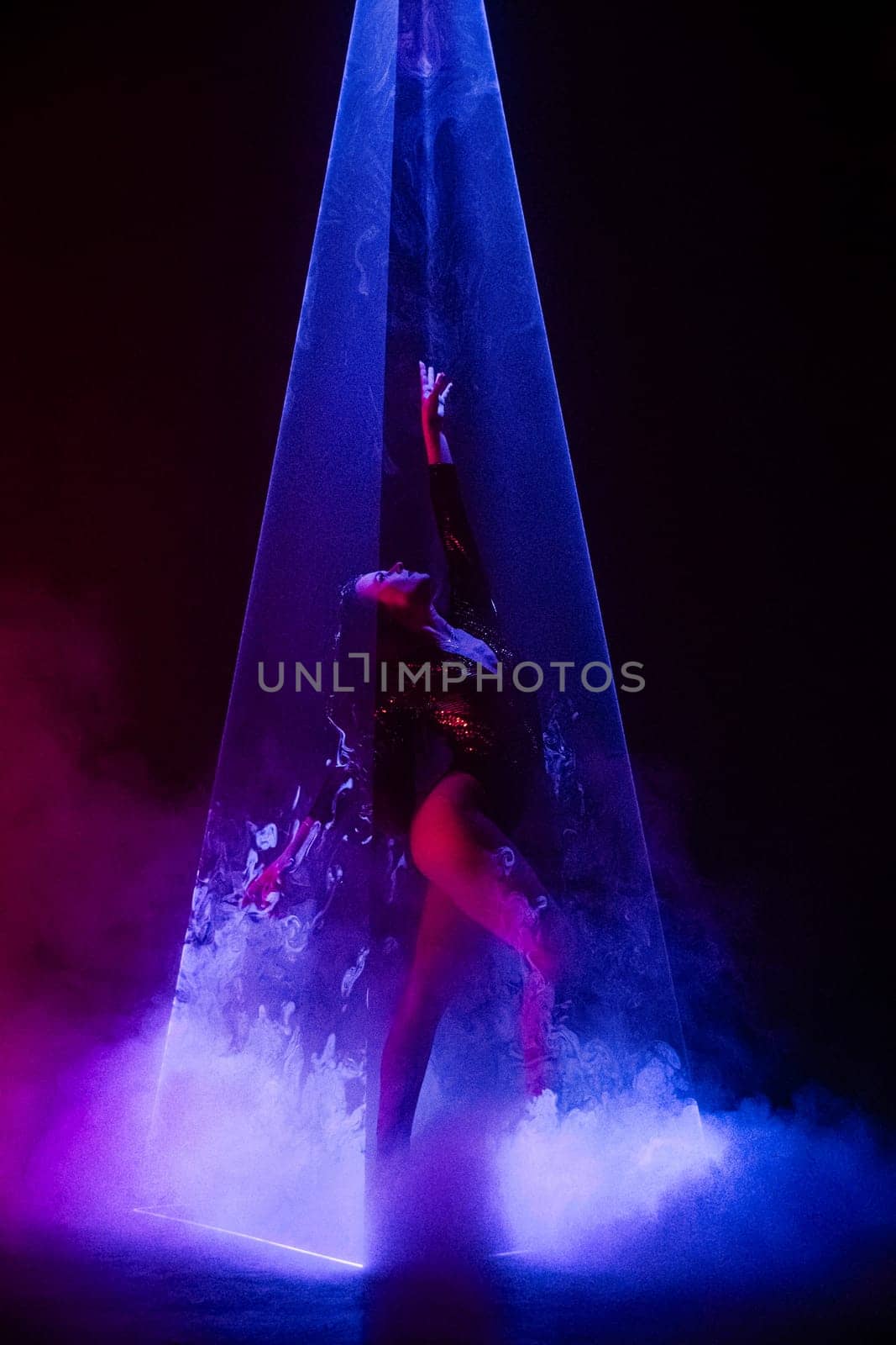 Gorgeous woman under colorful illumination, laser light, neon smoke club. Projection illusion mapping. Interactive installation. Optical visuals concept. High quality