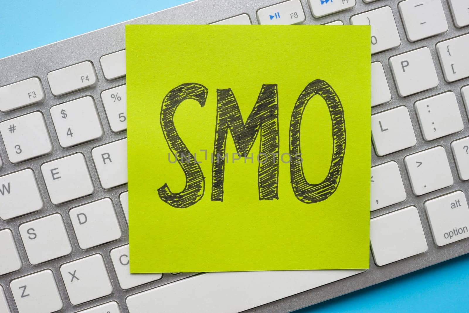 Close-up of a keyboard with a sticker SMO social media optimization. by designer491