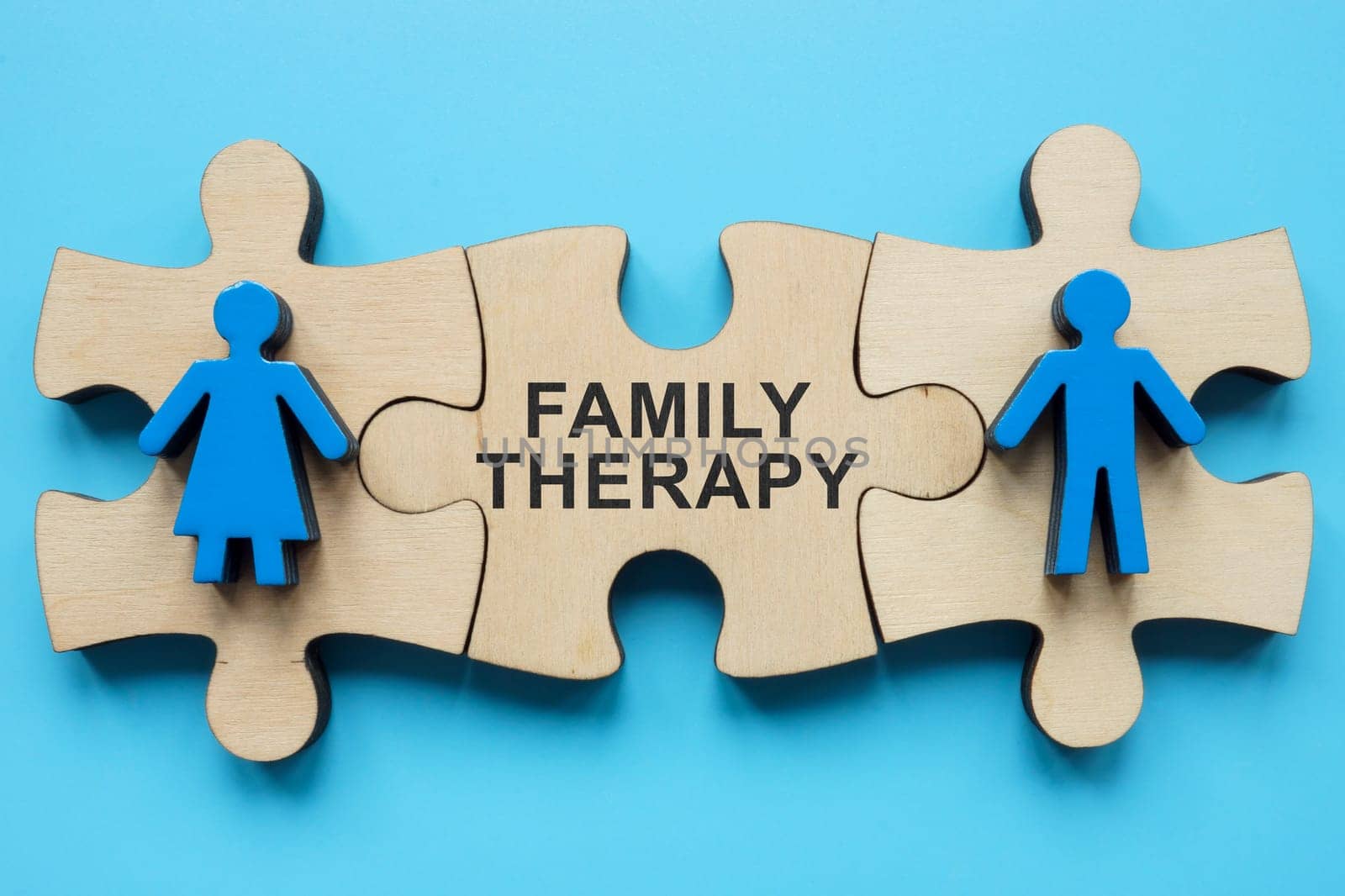 Family therapy concept. Puzzle pieces with figures and inscription. by designer491